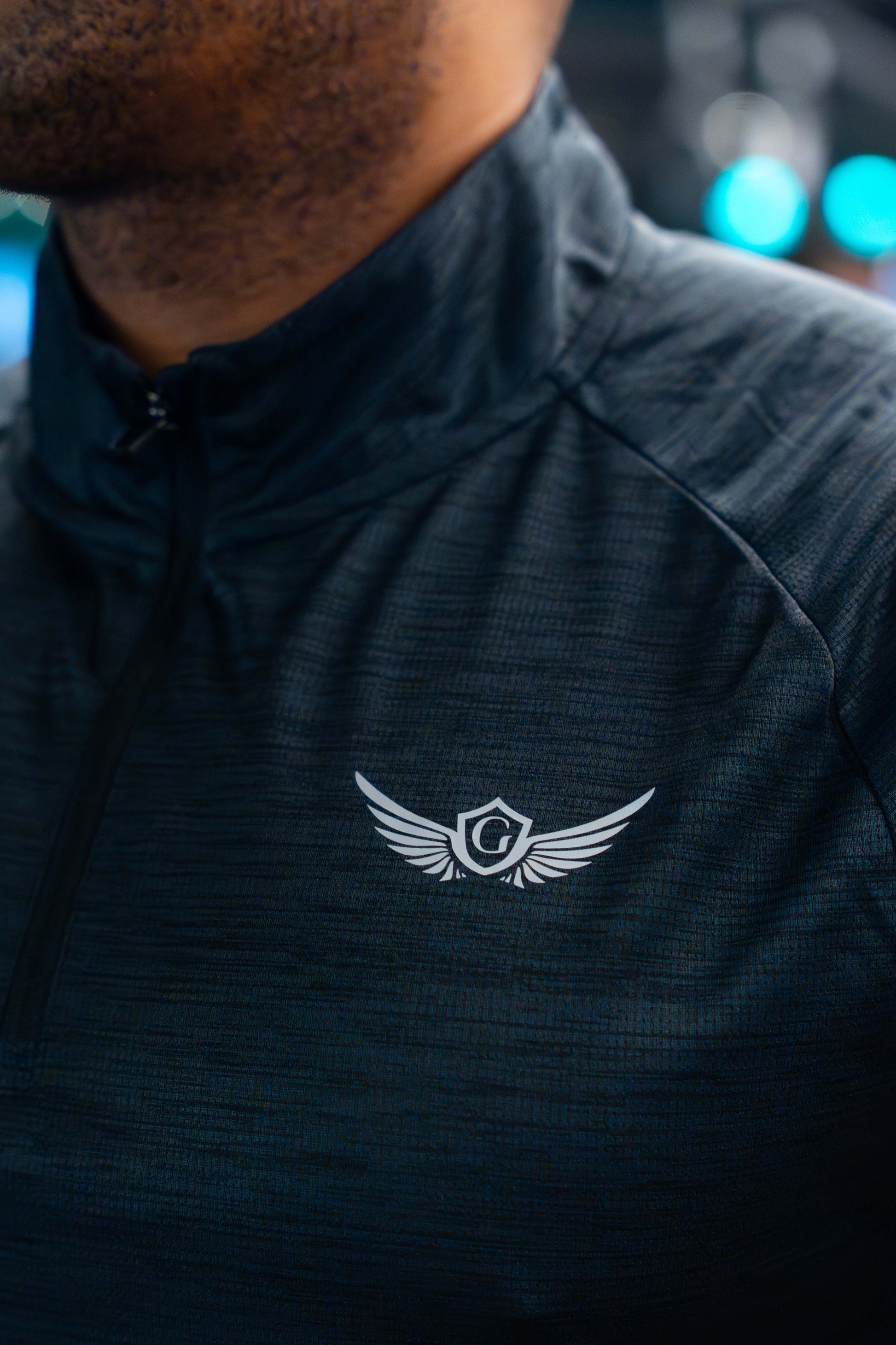 Black 1/4 zip on a blurred background