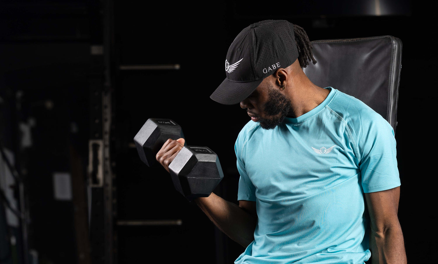 Man exercising with dumbbells in a gym setting